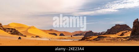 Vue panoramique sur la dune de sable du désert du Sahara et la montagne rocheuse hors route nature.Tadrar Rouge, Djanet, Illizi. ERG route poussiéreuse. Grès de couleur orange. Banque D'Images