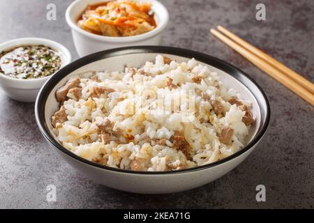Cuisine coréenne kongnamul riz bap avec pousses de soja et viande servi avec la sauce Yangnyumjang et kimchi gros plan sur la table. Horizontale Banque D'Images