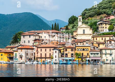 Monte Isola, Italie - 05-06-2022: Paysage du lac de Peshiera Maraglio à Monte Isola avec de belles maisons colorées reflétant dans l'eau Banque D'Images