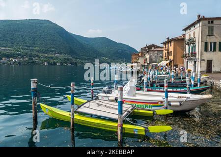 Monte Isola, Italie - 05-06-2022: Paysage du lac de Peshiera Maraglio à Monte Isola avec de belles maisons colorées reflétant dans l'eau Banque D'Images