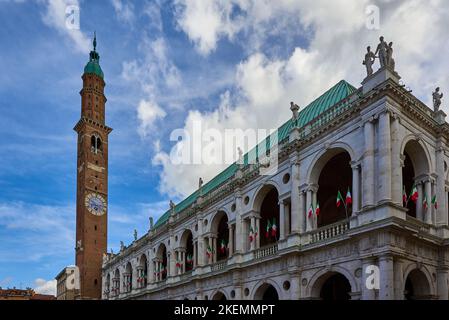 Vue sur la célèbre basilique Palladiana (Palazzo della Ragione) avec tour de l'horloge et drapeaux italiens situés sur la Piazza Dei Signori à Vicenza Banque D'Images