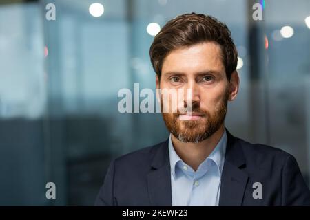 Gros plan d'un homme d'affaires sérieux et mature investisseur professionnel, homme regardant l'appareil photo avec concentration, patron de gestionnaire à l'intérieur du bureau au travail. Banque D'Images