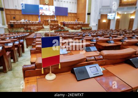 Bucarest, Roumanie - 14 novembre 2022 : drapeau roumain et sièges vides à la Chambre des députés roumaine à l'intérieur du Palais du Parlement. Banque D'Images