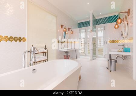 Décoration luxueuse et moderne dans la salle de bains avec armoires blanches, décoration en marbre blanc, douche de plain-pied, baignoire gratuite. Luxueux hôtel intérieur de station, élégant Banque D'Images