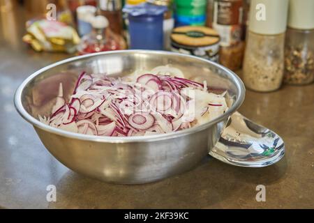 Oignon violet coupé en rondelles dans un bol pour la cuisson Banque D'Images