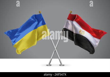 Deux drapeaux croisés Wavy de l'Égypte et de l'Ukraine, signe des relations égyptiennes et ukrainiennes Banque D'Images