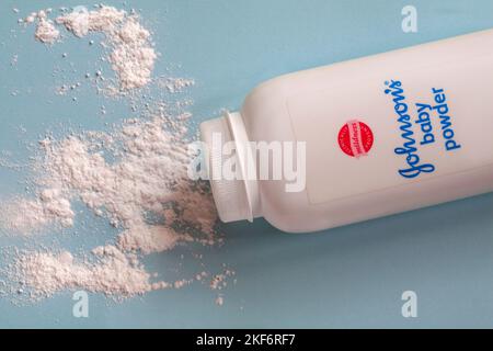 Johnsons Baby Powder Johnson et Johnson Baby Powder avec contenu renversé set sur fond bleu pâle - talc, talc poudre Banque D'Images