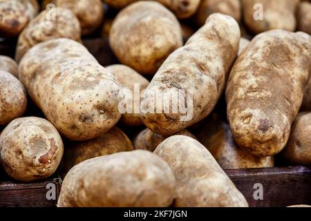 Pommes de terre fraîches biologiques empilées dans un panier à faible profondeur de champ Banque D'Images