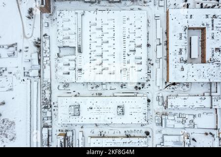 vue aérienne du quartier industriel en hiver. bâtiments de fabrication et entrepôts couverts de neige. Banque D'Images