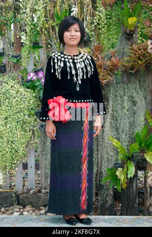 Une jeune femme Kachin ou Jingpo non identifiée vêtie d'une robe traditionnelle porte un headdress traditionnel montrant , au cours d'une représentation culturelle nationale. Banque D'Images