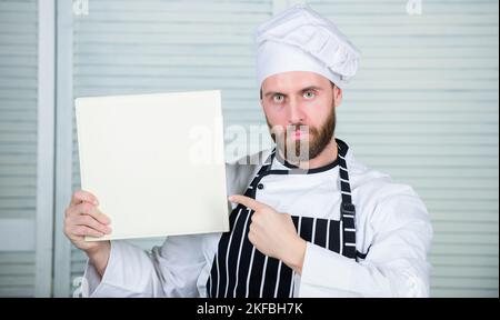 Améliorer les compétences de cuisson. Guide de cuisine ultime pour les débutants. Livre recettes de famille copier l'espace. Selon la recette. Homme barbu chef auteur du livre Banque D'Images