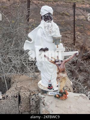 Petites statues de l'Obatala et de Jésus-Christ en croix sur le bord de la route. Dans les confessions d'Orisha, Obatalá est le ciel père. Banque D'Images