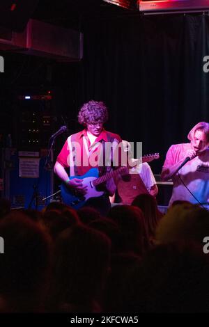 Avis tardif, un groupe de garage étudiant de l'État de Caroline du Nord joue un concert dans le centre-ville de Raleigh, en Caroline du Nord, devant une grande foule avec des lumières au néon et une excellente atmosphère. Banque D'Images