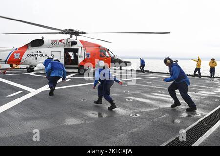 Un équipage d'hélicoptère de la station aérienne Kodiak MH-60 Jayhawk atterrit sur le pont de vol Healy (WAWB 20) de la Garde côtière dans le détroit de Kotzebue, en Alaska, tandis que les membres d'équipage de Healy déménagées pour installer des tirants le 7 septembre 2022. La formation est régulièrement menée pour maintenir les qualifications de l'équipage à bord des deux biens et accroître la compétence dans une variété de techniques. Banque D'Images