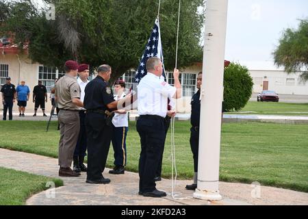 Lors d'une commémoration du jour du Patriot à 8 septembre 2022, un garde d'honneur composé de soldats du terrain d'essai Yuma de l'armée américaine, d'officiers de police et de pompiers se prépare à lever le drapeau américain pendant que la foule regardait. Le patter d'une pluie légère tombant sur des canapés au-dessus des chaises pliantes pour le public était le seul son entendu. Banque D'Images