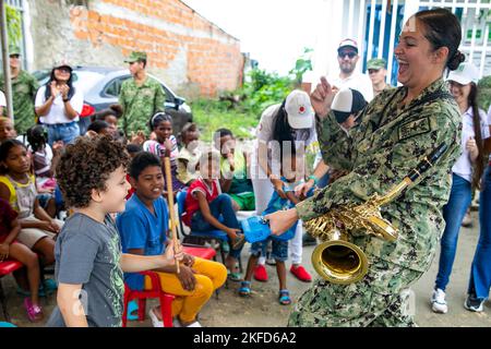 Cartagena, Colombie. 14th novembre 2022. Musicien 2nd classe Andrea Pharis, affecté au groupe de la flotte américaine et au navire de l'hôpital USNS Comfort (T-AH 20), joue la cloche de vache avec un enfant de la Fundacion Guerreros de Luz tout en se présentant dans un concert à Cartagena, Colombie, novembre. 14, 2022. Comfort est déployé à la flotte américaine 4th afin de soutenir la poursuite de Promise 2022, une mission d'aide humanitaire et de bonne volonté qui mène des soins médicaux directs, des soins vétérinaires expéditionnaires et des échanges d'experts en la matière avec cinq pays partenaires des Caraïbes, d'Amérique centrale et d'Amérique du Sud. (Crédit Banque D'Images