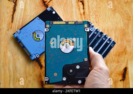 Hard disk drives are still widely used. hard drive in hand Banque D'Images