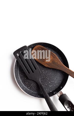 poêle à repasser avec spatule en bois, vue de dessus isolée sur fond blanc Banque D'Images