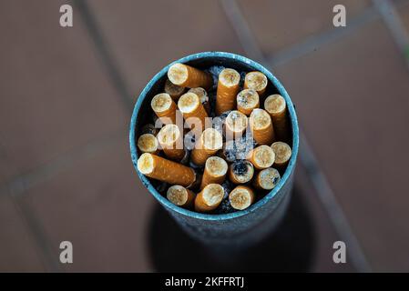 Cendrier circulaire rempli de mégots de cigarettes de tabac éteints Banque D'Images