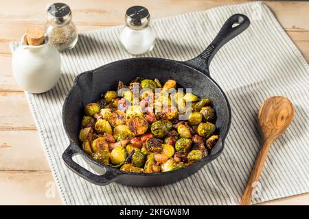 Pousses de brussel sautées faites maison avec du bacon et de l'huile d'olive Banque D'Images