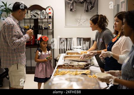 Des bénévoles servent de la nourriture aux participants lors d'une célébration de la fête de l'indépendance mexicaine au camp de Foster de l'USO, Okinawa, Japon, le 16 septembre 2022. Les employés et les bénévoles de l'USO ont organisé la célébration de la Journée de l'indépendance du Mexique pour les membres du service et leurs familles pendant le mois du patrimoine hispanique. Le rassemblement comprenait des spectacles en direct et des plats traditionnels originaires du Mexique et d'Amérique du Sud. Banque D'Images