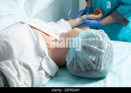 Patiente en salle d'opération à l'hôpital, prête pour la césarienne Banque D'Images