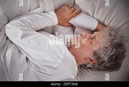 Femme âgée, lit et insomnie stress à la maison tandis que fatigué, inquiétude et anxiété à la retraite. Femme âgée, chambre à coucher et santé mentale avec Banque D'Images