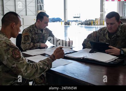 De gauche à droite, U.S. Air Force Tech. Sgt. Joshua-James Lee, technicien en système de navigation de communication de l'escadron de maintenance des aéronefs 945th, Sgt. Brett Williams, spécialiste de la production de la gestion de la maintenance du Groupe de maintenance 60th, et Tech. Sgt. Clayton Cahoon, chef du quai de l'escadron de maintenance des aéronefs 860th, participe à une réunion préparatoire à la vérification de la station d'accueil à la base aérienne de Travis, en Californie, le 13 octobre 2022. Ces spécialistes de la production en gestion de l'entretien travaillent avec les chefs d'équipage et les mécaniciens pour planifier, planifier et organiser l'entretien des véhicules aérospatiaux afin de s'assurer que l'équipement et Banque D'Images