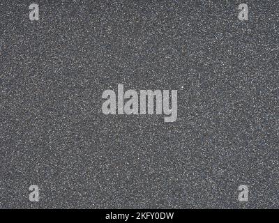 Gros plan à texture pailletée gris foncé. Motif holographique scintillant brillant pour la décoration et le design de Noël extravagant et insolite Banque D'Images