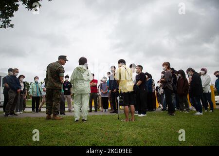 Le lieutenant-colonel Danie N. Saaiman, officier exécutif, quartier général et bataillon de soutien, installations de corps maritimes du Pacifique, camp de base de corps maritimes et résidents locaux participent à un exercice d'évacuation tsunami durant l'exercice constant vigilance 2022 sur le camp Foster, Okinawa, Japon, le 18 octobre 2022. L'exercice annuel a été organisé pour transmettre l'état de préparation et les capacités du camp aux membres et aux communautés locales en cas d'urgence. CV22 est une évaluation de la condition de protection de la Force et de l'intervention en cas de crise visant à valider les installations régionales, les camps et le plan antiterroriste des locataires Banque D'Images