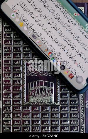 Coran numérique sur une tablette et Coran traditionnel sur papier. Banque D'Images