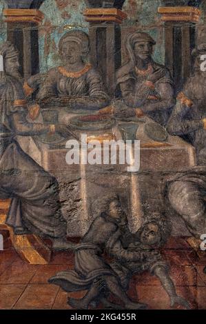 Les jeunes se battent sur le sol alors que leurs parents s'atttent à la table à manger : la peinture murale humaniste de la fin du 16th siècle peinte par Christian Vacksterffer sur la Maison Pfister de Colmar, Alsace, Grand-est, France, construite en 1537 pour un riche membre de la bourgeoisie mercantile de la ville peut-être décrite ici dans une conversation polie. Banque D'Images