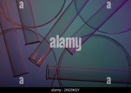 Vue de dessus des boîtes de Petri et des tubes à essai à la lumière du néon. Laboratoire cosmétique ou médecine, biologique, recherche chimique, vue de dessus en éclairage au néon. Banque D'Images