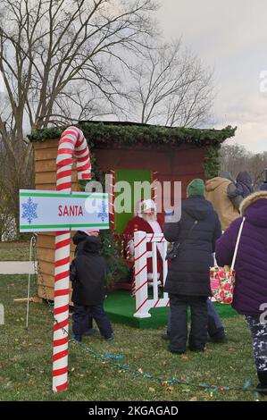 South Elgin, Illinois, États-Unis. Une longue file de parents avec des enfants attendant de voir le Père Noël par une journée très froide et trouilleuse. Banque D'Images