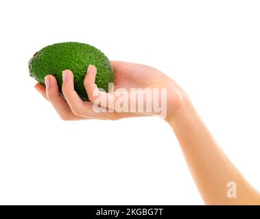 Beaucoup de bonté saine dans votre paume. Vue rognée d'une main de femme tenant un avocat. Banque D'Images