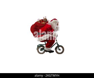 Santaclaus fait du vélo pour offrir des cadeaux de noël rapides Banque D'Images