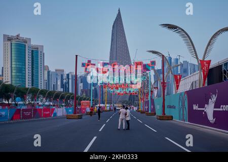 Photo de la corniche de Doha au coucher du soleil montrant la préparation du Qatar pour la coupe du monde de la FIFA Qatar 2022 avec les habitants et les visiteurs marchant sur la promenade Banque D'Images