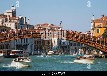 Passerelle de l'Accademia avec des touristes sur le Grand Canal avec des bateaux-taxis et bâtiments résidentiels Renaissance, San Marco, Venise. Banque D'Images