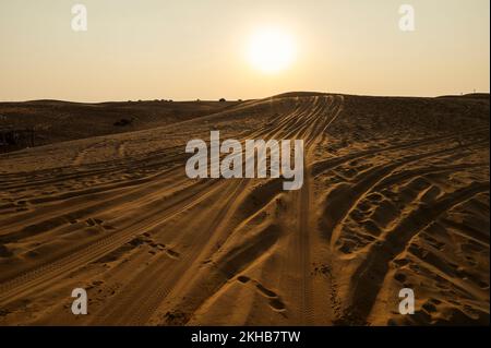 Marques de pneus de voiture sur les dunes de sable du désert de Thar, Rajasthan, Inde. Les touristes arrivent sur des voitures pour regarder le soleil se lever dans le désert , une activité touristique très populaire . Banque D'Images