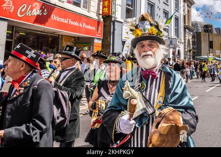 Un costume flamboyant de caractère avec le groupe Raffady Dumiitz dans une procession le jour de Mazey pendant le Golowan Festival à Penzance, en Cornouailles. Banque D'Images