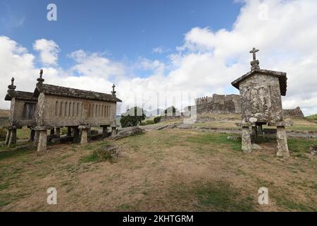 Un vieux grenier (espigueiros) et le château au-dessus du village de Lindoso dans le Parque Nacional da Peneda-Geres, dans le nord du Portugal. Banque D'Images