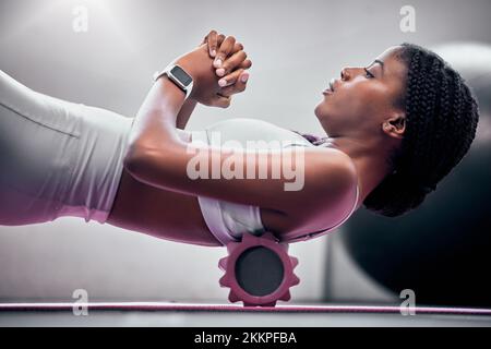 Yoga, sol et femme noire avec rouleau en mousse pour le massage, les soins de santé ou le soutien du dos aider dans le club de santé, le studio ou la salle de gym. Soulagement musculaire, sport Banque D'Images