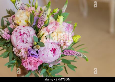 Bouquet riche de péonies roses et de fleurs lilas eustoma roses, feuille verte . Bouquet de printemps frais. Holodays, cadeau.Arrangement de belle floraison Banque D'Images