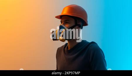 un homme dans un masque avec un filtre et un fond de couleur de casque Banque D'Images