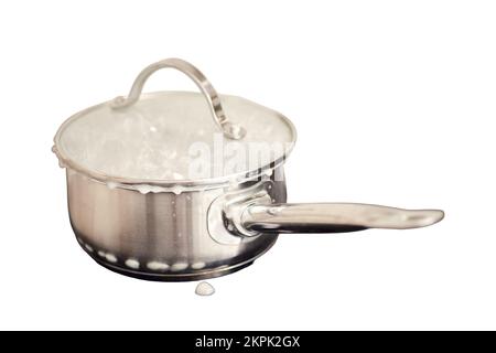 Le porridge de lait a été versé pendant l'ébullition sous le couvercle de la casserole sur un poêle à induction électrique, isolé sur un fond blanc Banque D'Images