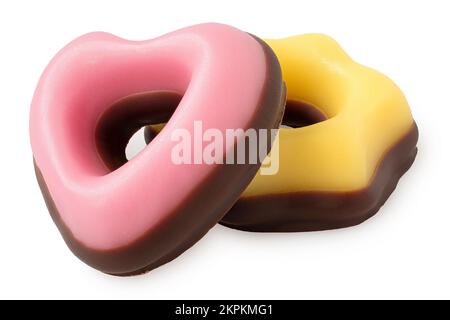 Bonbons de noël jaune et rose trempés dans du chocolat isolé sur du blanc. Banque D'Images