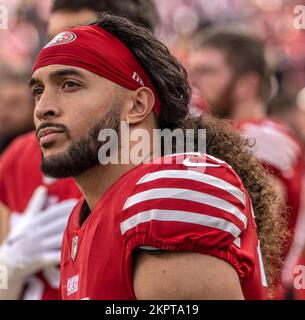 San Francisco 49ers safety Talanoa Hufanga, left, poses for photos with  former 49ers player Jesse Sapolu, middle, while exchanging jerseys with  Miami Dolphins quarterback Tua Tagovailoa, right, after an NFL football game