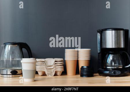 Gros plan de la cafetière et de la théière avec des tasses écologiques pour préparer le café pendant la pause-café au bureau Banque D'Images