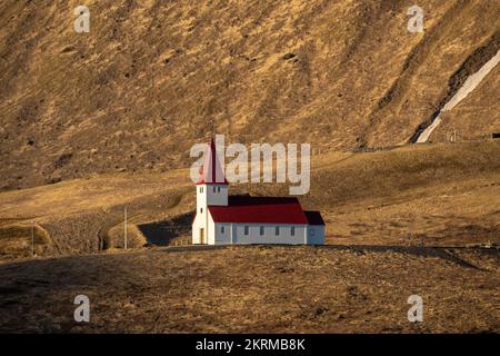 L'église de Reyniscyrka est située sur une colline herbeuse dans la campagne le jour ensoleillé à Vik, en Islande Banque D'Images