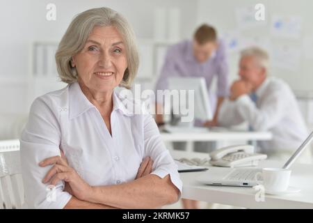 portrait d'une vieille femme d'affaires sur le fond d'un bureau Banque D'Images